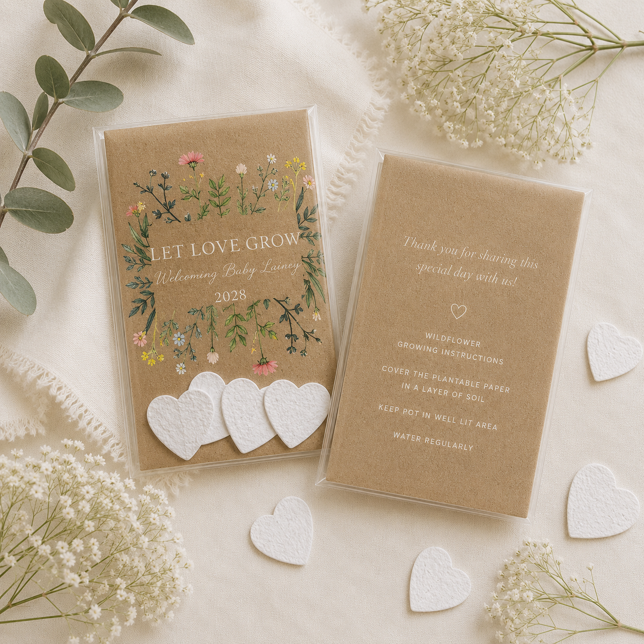 Plantable baby shower favours featuring four handmade wildflower seed paper hearts with personalised cards, a meaningful eco-friendly guest gift.
